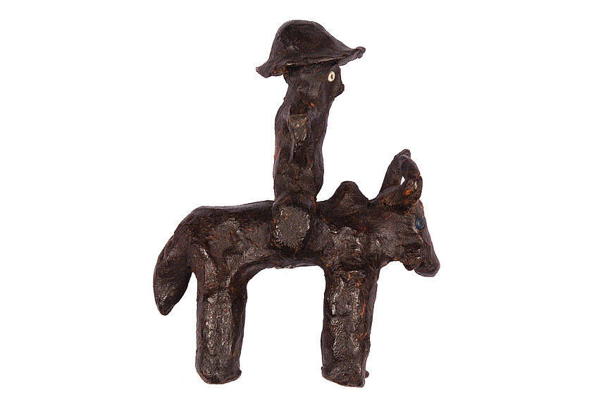 Figurine de cavalier montant un bœuf