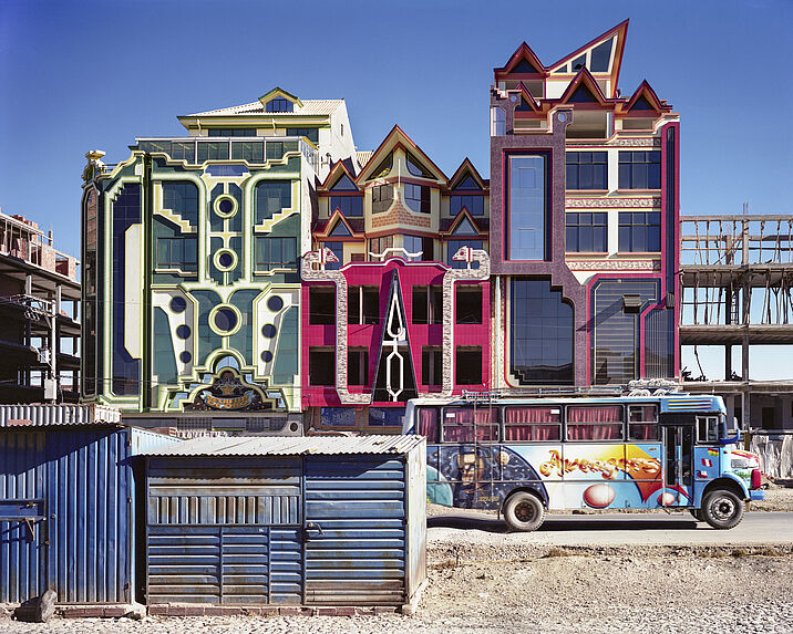 Colorful bus passing in front of cholets under construction