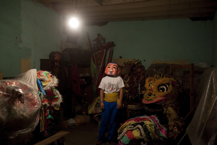 A young man, who has been learning the Dance of the Lion, in a Chinatown warehouse